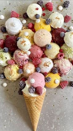 an ice cream cone filled with lots of different types of desserts on top of it