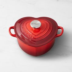 a red pot with a heart shaped lid