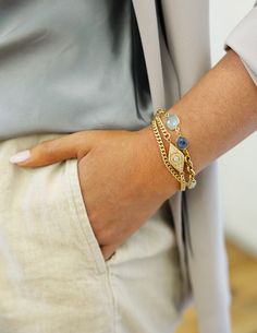 The perfect bracelet for mixing and stacking, this gold mixed chain bracelet shines with a contemporary design with its moonstone, kyanite and chalcedony gemstones. Expertly crafted and made with a modern appeal, wear this delightful piece to elevate a casual look. Truly perfect all by itself or layered with other lengths and textures to create your statement look. Length: 7 1/2” The chain is 14K gold plated over brass with a burnished finish Gemstones are Kyanite, Chalcedony and Moonstone All m Double Wrap Bracelet, Bold Jewelry, Jewelry Post, Stacked Jewelry, Eye Bracelet, Long Pendant, Blue Chalcedony, Single Earring, Everyday Jewelry