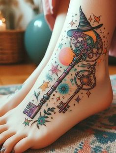 a woman's foot with a wizard hat and key tattoo on the bottom of it