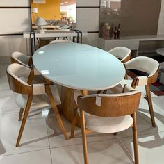 a dining table and chairs in a room with white tile flooring on the floor