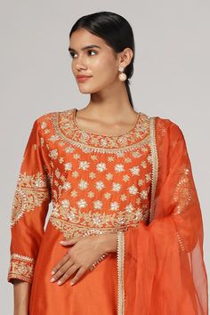 Orange silk chanderi kurta with zari and aari embroidery. Comes with salwar and an organza dupatta. - Aza Fashions Silk Churidar With Zari Work For Festive Occasions, Eid Traditional Wear With Zari Work In Slub Silk, Transitional Chanderi Salwar Kameez With Resham Embroidery, Festive Raw Silk Salwar Kameez With Zari Work, Straight Churidar In Art Silk With Cutdana, Transitional Salwar Kameez With Gota Work, Festive Raw Silk Salwar Kameez, Diwali Designer Slub Silk Traditional Wear, Festival Raw Silk Salwar Kameez With Zari Work