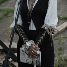 a woman in black and white outfit holding a microphone