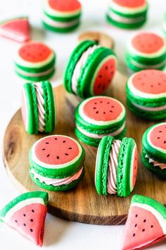 some watermelon cookies are on a wooden plate