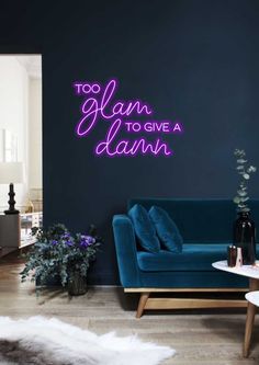 a living room filled with furniture and a neon sign on the wall that says, too glam to give a dawn