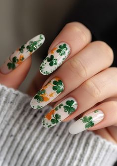 Let your nails reflect the joy of St. Patrick's Day with these fresh white nails, adorned with an array of green and orange clovers, bringing a festive and fun vibe to your look. Explore more fun nail art options at nailhow.com. Green White Nails, St Patrick's Day Nails, Fun Nail Art, St Patricks Day Nails, Tinted Glasses, Different Shades Of Green, Festival Nails, Wear Green, Fabulous Nails