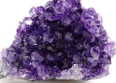 a pile of purple crystals sitting on top of a white table