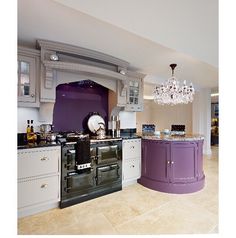 a kitchen with an oven, sink and chandelier