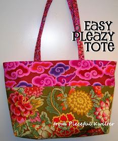 a pink and green floral bag hanging on a wall next to a white wall with a red handle