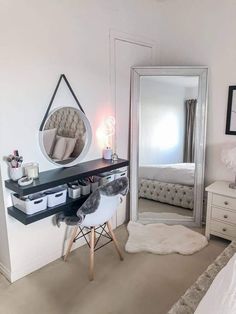 a bedroom with a mirror, desk and chair