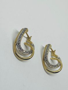 "This is a classic, vintage pair of 10K yellow gold, 10K white gold, and diamond loop-design dangle/drop earrings. Material(s): 10K yellow gold + 10K white gold + several small diamonds Total weight: 3.4 grams Flaws (if any): None to mention Marking(s): \"10K\" If you have any questions about this pair of earrings, please do not hesitate to contact us! ♥" Classic Gold Diamond Earrings Hallmarked, Classic Gold Hallmarked Diamond Earrings, Hallmarked Pear-shaped White Gold Diamond Earrings, Yellow Gold Drop Hoop Earrings For Anniversary, Pear-shaped Hallmarked White Gold Diamond Earrings, Anniversary Yellow Gold Drop Hoop Earrings, Hallmarked Pear-shaped Diamond Earrings For Anniversary, Pear-shaped Hallmarked Diamond Earrings For Anniversary, Gold Hallmarked Teardrop Diamond Earrings