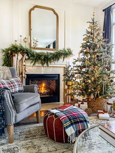 a living room with a christmas tree in the corner and other decorations on the fireplace