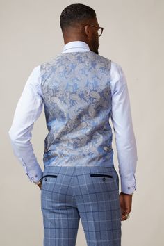 Like a breath of fresh air, this Kelvin sky blue waistcoat will instantly revive your look. An ideal mix-and-match piece, it looks perfect for spring/summer events in its playful sky blue shade. The bespoke MD paisley print lining adds personality and the textured fabric keeps it contemporary. With two buckle adjuster straps to the back you'll have the ability to create a perfectly contoured shape. Also available in a single-breasted option. Model wears size 38R. Features Slim fit Double-breaste English Gentleman, Double Breasted Waistcoat, A Breath Of Fresh Air, Breath Of Fresh Air, 3 Piece Suits, Summer Events, Pocket Square, Fresh Air, Paisley Print