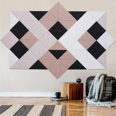 a living room with a rug, chair and wall hanging on the wall in front of it