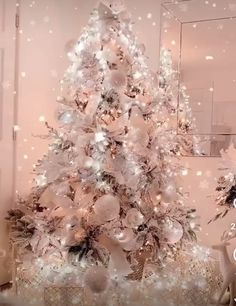 a white christmas tree with ornaments and lights