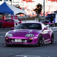 a purple sports car parked in a parking lot