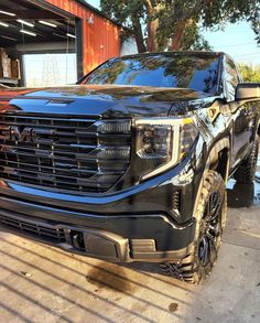 a black truck parked in front of a building