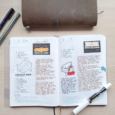 an open book with writing on it next to a pen and some other items that are sitting on the table