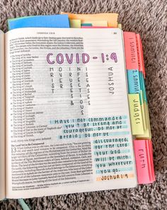 an open bible with the words covidd - 19 printed on it and colored markers