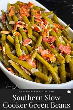 southern slow cooker green beans in a white bowl with bacon on top and text overlay that reads southern slow cooker green beans