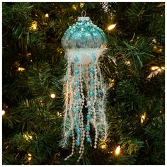 a blue and white ornament hanging from a christmas tree