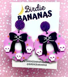 ... Halloween Wreath Earrings!  Perfect for a hint of kitschy spookiness on Halloween or any day!!  Very lightweight and easy to wear!  Features Acrylic wreaths with black bow and a trio of skulls completed with hand painted details. Topped with a sparkly purple stud. Finished with stainless steel posts and jump rings  Size  Width 5cm Length 6.5 cm Shipping and Handling I aim to ship same or next business day. Shipping is standard and generally takes 2-6 business days.  If you require tracking o Cute Halloween Party Jewelry, Purple Earrings For Halloween Party, Halloween Cat Ears Earrings, Novelty Purple Earrings For Party, Purple Novelty Earrings For Party, Wreath Earrings, Earrings Kawaii, Earrings Halloween, Kawaii Halloween