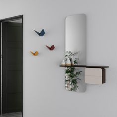 there is a mirror and some birds on the wall in this room with white walls