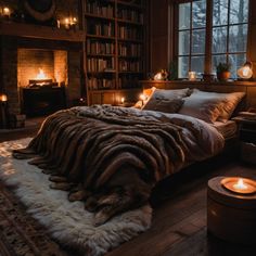 a cozy bedroom with candles lit in the windows