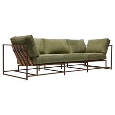 a green couch sitting on top of a metal frame