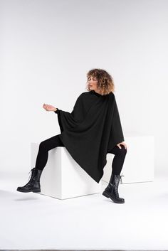 "Super warm asymmetrical knitted poncho. The model in the picture is 176cm. ⅼ 5.8 ft. tall and is wearing size S / color: Black 🌟 INFO: * Worldwide EXPRESS shipping - please provide a phone number for shipping documents * US Sizing XS to 4XL - size chart available below - all measurements of the body * We offer customization to Personal Measurements & Larger Sizes 5XL, 6XL, 7XL .... 🌟 MATERIAL & CARE * fabric: acrylic wool-cotton mix * hand wash * cold water 30 degrees * iron at medium Gothic Cape, Plus Size Poncho, Shipping Documents, Poncho Women, Plus Size Goth, Winter Poncho, Goth Clothing, Ladies Poncho, Wool Winter