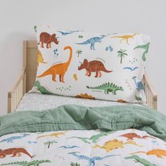 a child's bed with dinosaurs on it