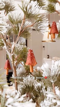 christmas decorations hanging from the branches of a pine tree