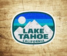 the lake tahoe california sticker is on a wooden surface