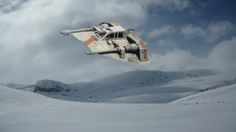 a space ship flying through the air over snow covered ground and mountains in the background