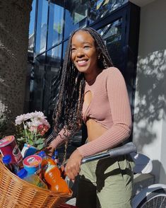 a woman standing next to a basket full of food