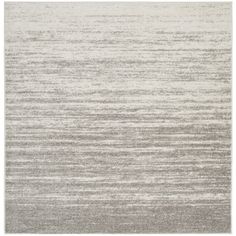 a gray and white rug with horizontal stripes on the bottom, in an area that is very