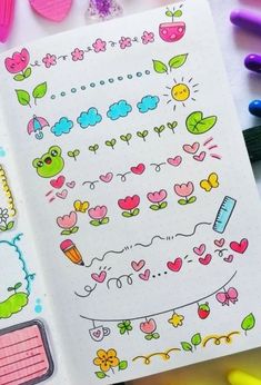 an open notebook with stickers on it and some crayons next to it