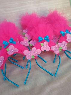 four pink and blue hair clips with flowers on them