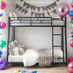 a bunk bed is surrounded by balloons and streamers