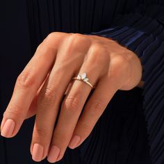 a woman's hand with a ring on it