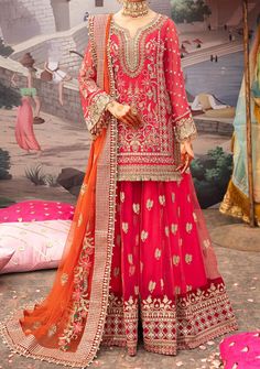 a woman in a red lehenga and orange dupatta