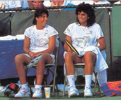 two female tennis players sitting next to each other