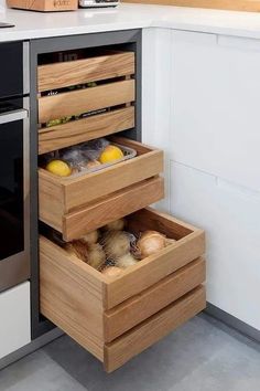 an open drawer in the middle of a kitchen