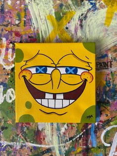 a yellow spongebob with blue eyes and big smile on it's face