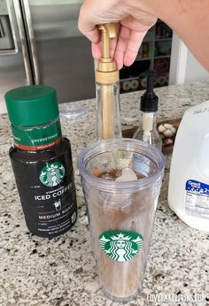 someone is pouring coffee into a starbucks cup