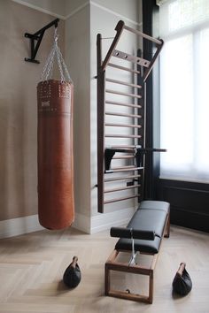 a living room with a punching bag and boxing gloves on the floor next to it