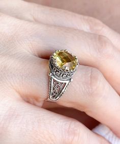 "This everyday use, lace embroidery minimalist sterling 925 sterling silver filigree art crown cocktail ring has citrine gemstone. The ring face is 0.47\" / 12.00 mm. Citrine gemstone is 10 mm, double side faceted, checkerboard round-cut. It takes its name from the citron fruit because of these lemon-inspired shades. Citrine is the traditional birthstone for November, and is an alternate Zodiac stone for Scorpio. This yellow stone, filigree art, dainty ring would make the perfect option for a bi Yellow Filigree Jewelry Gift, Gold Sterling Silver Filigree Ring With Gemstone, Elegant Silver Citrine Jewelry, Elegant Silver Jewelry With Citrine, Exquisite Citrine Rings As A Gift, Sterling Silver Filigree Ring With Gemstone For Gift, Elegant Yellow Ring Stamped 925, Exquisite Filigree Ring With Gemstone For Gift, Exquisite Gemstone Filigree Ring As A Gift