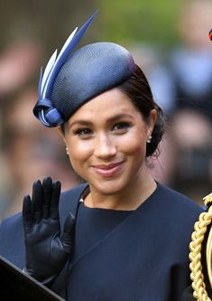 a woman wearing a blue hat and black gloves