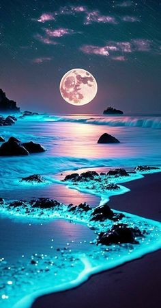 the full moon is shining brightly over the water and rocks on the beach at night