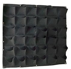 a black wall hanging organizer with multiple pockets on the front and bottom, attached to a white background